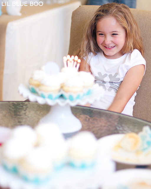 Blowing out the candles! Frozen Winter Snowflake Birthday Party via Ashley Hackshaw / lilblueboo.com #frozen