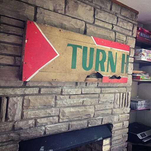 Artwork above my fireplace using a reclaimed sign 