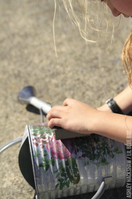 Sanding down the painted flowers to distress them