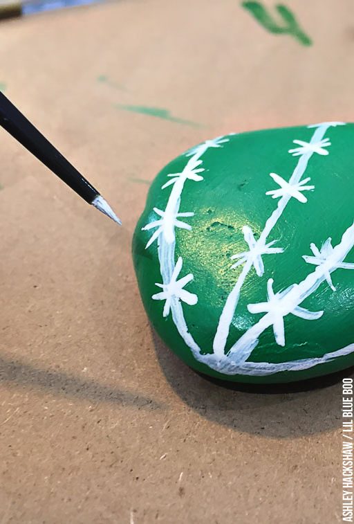 Hand painting rocks to look like a cactus or vegetable