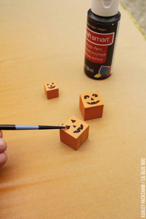 Painting a jack-o-lantern face for pumpkin