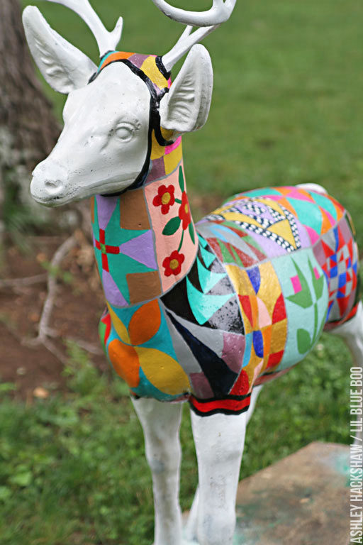 Painting a barn quilt onto a deer statue