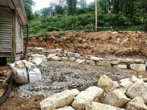 Farmhouse Renovation Rock Retaining Wall - Sixty-One Park Farmhouse